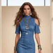 Woman wearing a blue dress with cut-out shoulders against a beige background