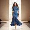 Model wearing a blue dress on a runway