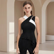 Woman wearing a black and white dress in an elegant interior setting