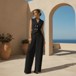 Woman in a black outfit standing in front of arches with a scenic background
