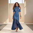 Woman wearing a blue dress on a runway