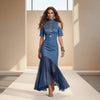 Woman wearing a blue dress on a runway