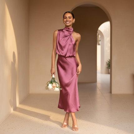 Woman in a pink dress standing in a sunlit archway
