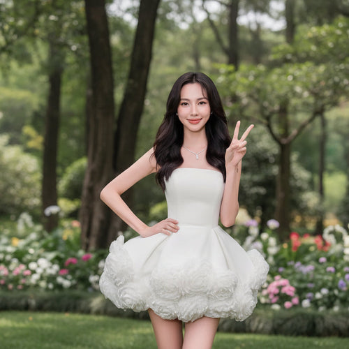 Woman wearing a white dress with floral details on a black background