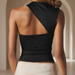Black sleeveless top with open back worn by a person, beige background