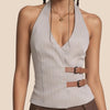Light gray pinstripe halter top with a brown belt on a beige background