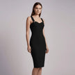 Woman wearing a black NORVANE Riviera Bandage Dress against a plain background
