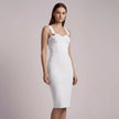 Woman wearing a white NORVANE  dress against a plain background