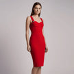 Woman wearing a red NORVANE Riviera Bandage Dress against a plain background