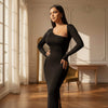 Woman in a black dress standing in a sunlit room with wooden floors and white walls.