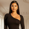Woman wearing a black one-shoulder dress in an elegant interior setting
