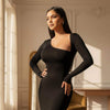 Woman wearing a black dress in an elegant room with sunlight streaming through the window.