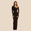 Woman wearing a black one-shoulder dress on a beige background