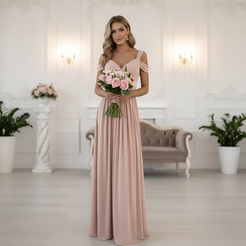 Woman wearing a pink slit dress, holding a bouquet of pink flowers in an elegant interior.