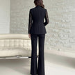 NORVANE black polyester blazer with lace sleeves and matching tailored cropped trousers.