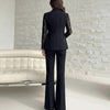NORVANE black polyester blazer with lace sleeves and matching tailored cropped trousers.