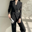 NORVANE black polyester blazer with lace sleeves and matching cropped trousers, single-button closure.