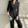 NORVANE black polyester blazer with lace sleeves and matching cropped trousers, single-button closure.