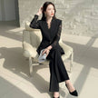 NORVANE black polyester blazer set with lace-panelled sleeves and cropped trousers.