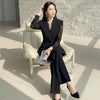 NORVANE black polyester blazer set with lace-panelled sleeves and cropped trousers.