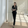 NORVANE black polyester blazer set with lace-panelled sleeves and cropped trousers.